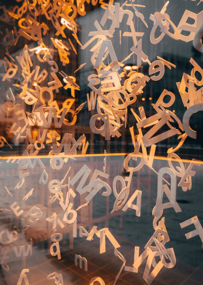 Creative alphabet installation with a glass window reflection in Vilnius, Lithuania.
