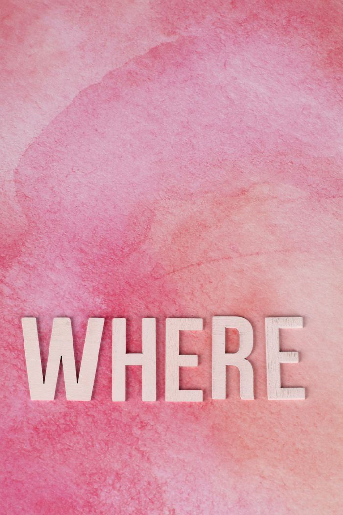 Stylized word 'WHERE' on a pink watercolor background, offering copyspace.